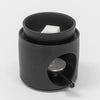 Elegant ceramic wax melt burner. The burner, featuring a matte black finish, includes a separate melting bowl and a tealight holder. 